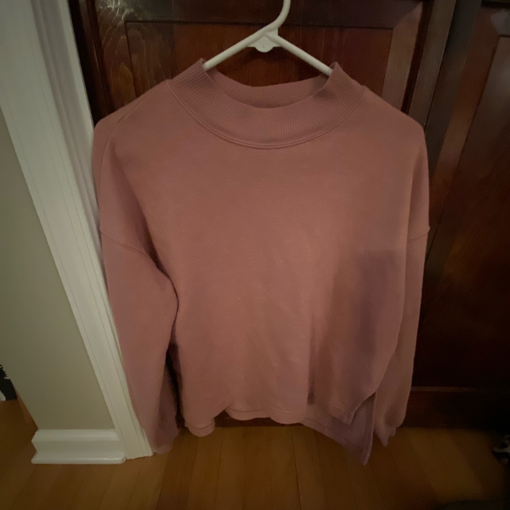 A light pink mock neck sweatshirt that’s in very soft and comfortable